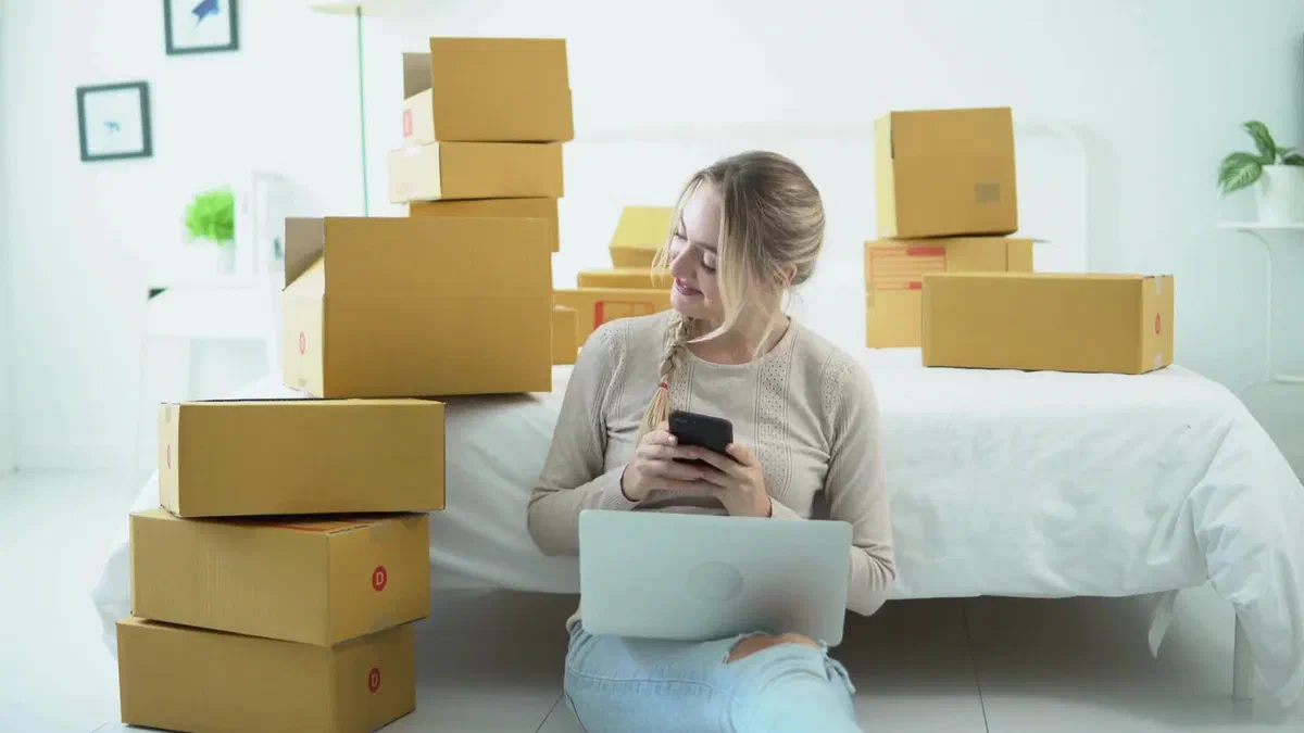 Customer surrounded by delivered packages at home
